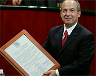 Calderon proudly holds hiswinner's certificate
