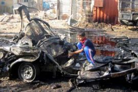 boy on car bomb wreckage