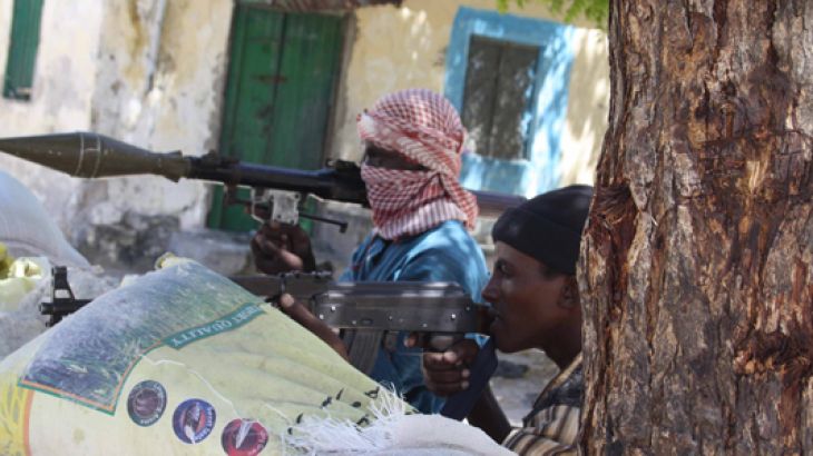 Somalia militant fighters aim guns