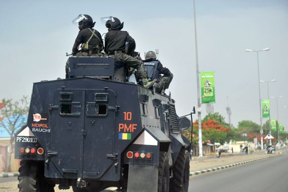 A picture taken on April 18, 2011 shows Nigerian police enforcing a curfew in the capital of Bauchi state, nothern Nigeria