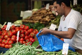 Market trader selling fruit and vegetables