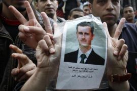 Syrian university students in Lebanon, flash victory signs as they carry a picture of Syria''s President Bashar al-Assad during a demonstration in front of the Syrian embassy in Beirut