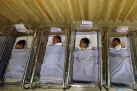 File photo shows babies lying in cots at a maternity ward in Singapore