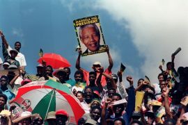 African National Congress (ANC) supporters listen to an address by Nelson Mandela in March 1994 [File: Walter Dhladhla/AFP]