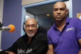 Former Surinamese dictator Desi Bouterse, head of the opposition National Democratic Party (NDP), pose with his son Dino during a live radio show in Paramaribo