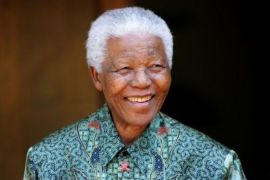 File photo of Nelson Mandela greeting photographers in Johannesburg
