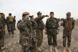 Kurdish Peshmerga troops gather on the outskirts of Kirkuk [Reuters]