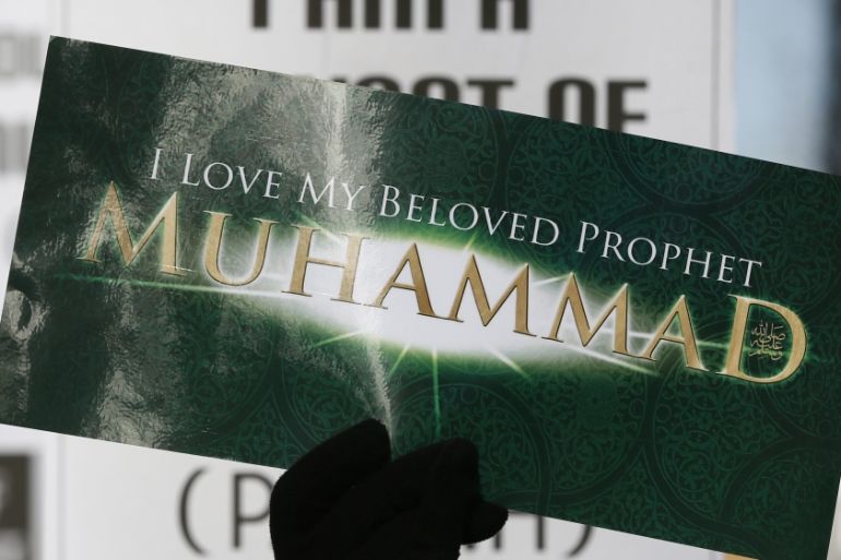 A Muslim demonstrator holds a placard during a protest against the publication of cartoons depicting the Prophet Mohammad in Charlie Hebdo, near Downing Street in central London