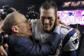 New England Patriots quarterback Tom Brady is congratulated by team president Jonathan Kraft after defeating the Seattle Seahawks in the NFL Super Bowl XLIX football game in Glendale