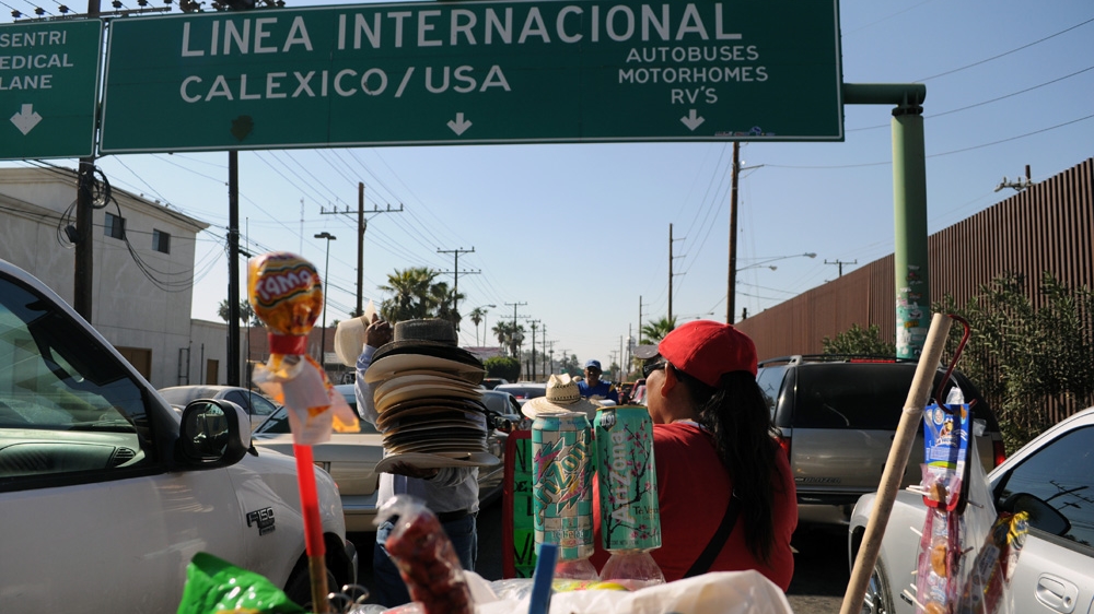 Hawkers in Mexicali, Mexico, sell goods in the street as cars wait to cross the border into the US [Joe Jackson /Al Jazeera] 