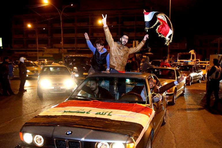 Iraqis celebrate after the lifting of Baghdad''s night-time curfew
