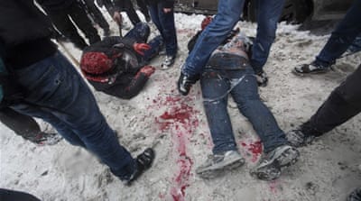 Members of a pro-Kremlin youth group douse two tied-up spice pushers with red paint [AP] 