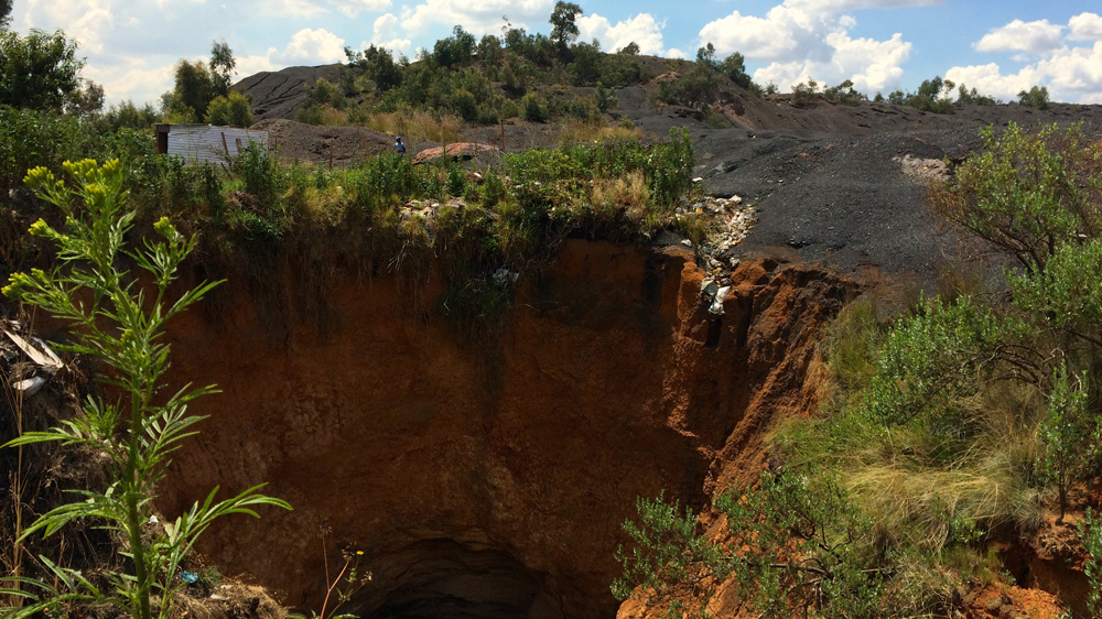 Sink holes from abandoned mine shafts are among many of the hazards facing local residents [Victoria Schneider/Al Jazeera]