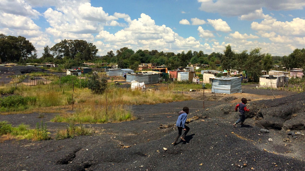 Children at play near the illegal settlements built on a former coal mine [Victoria Schneider/Al Jazeera]