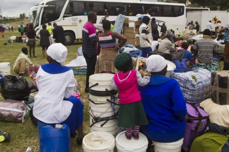 Foreigners from Zimbabwe wait to leave on a bus home, from a camp for those affected by anti-immigrant violence in Chatsworth, north of Durban