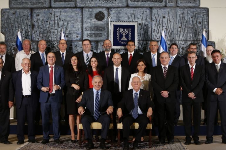 Members of the newly sworn in 34th government of Israel pose for a group photo at the presidential compound in Jerusalem on May 19, 2015 [Getty]
