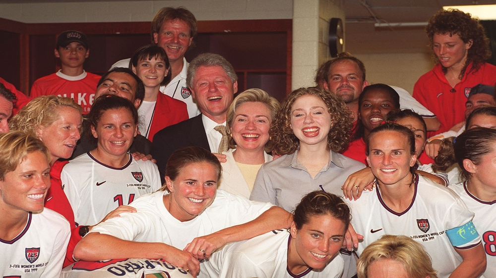 Bill, Hillary and Chelsea Clinton join the US women's football team in the locker room after their Women's World Cup quarter-final victory against Germany on July 1, 1999 [AFP/Getty images]