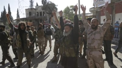 Members of Nusra Front cheer in the northwestern city of Ariha, after seizing the area in Idlib province [REUTERS]