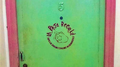 The door to punk rocker Gorki Aguila's apartment - and recording studio [Creede Newton/Al Jazeera]