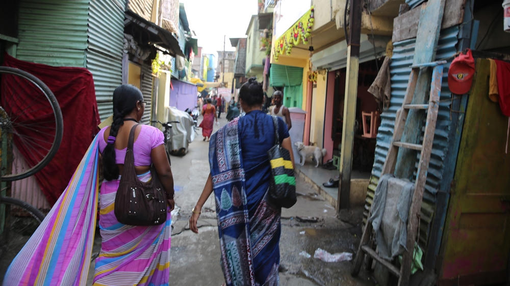 Bapu Trust workers walking their regular route through the slums of Pune [Emi Sasagawa/Al Jazeera]