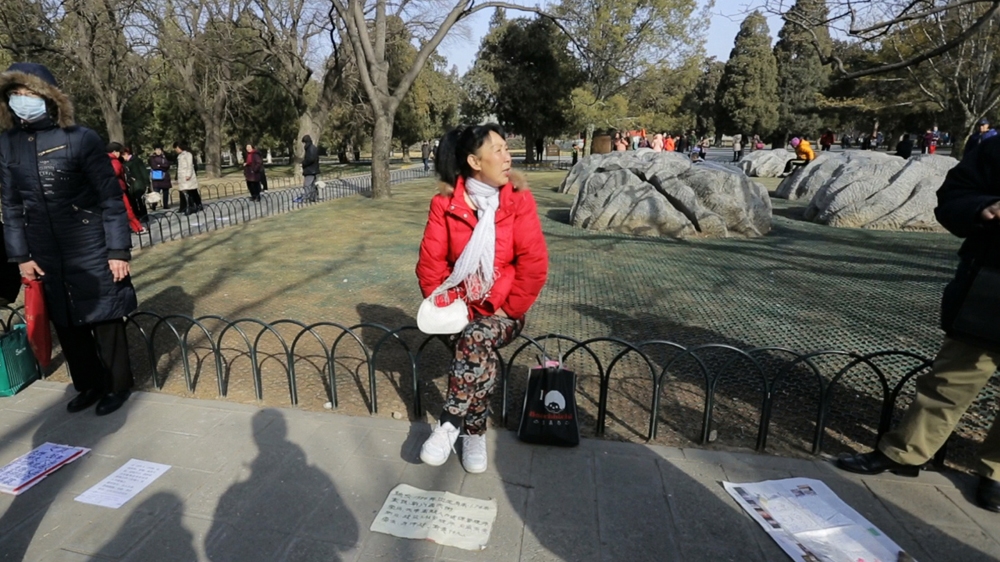 In a Beijing park, the parents of unmarried women and men gather in the hope of finding a spouse for their offspring [Katrina Yu/Al Jazeera]