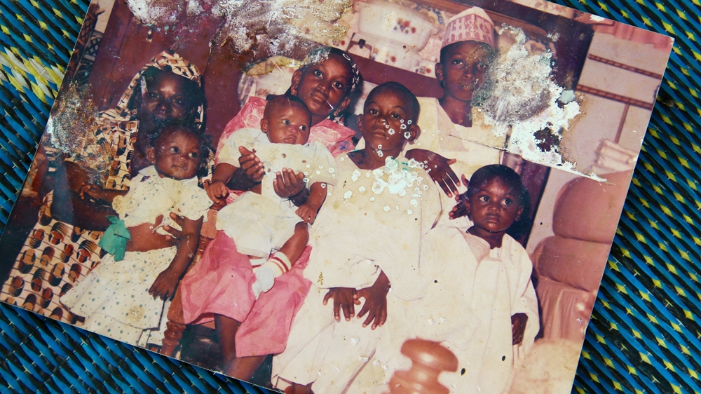 A family picture taken about 20 years ago. Aliyu Mohammed is the third boy on the right, his mother is on the far left and his brother Abubakar is on the far right [Femke van Zeijl/Al Jazeera]