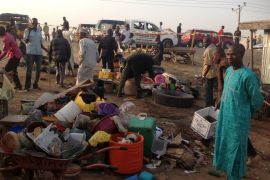 People gather at the scene of a bomb blast at a fruit and vegetable market in the Jimeta area of Yola, Adamawa, Nigeria