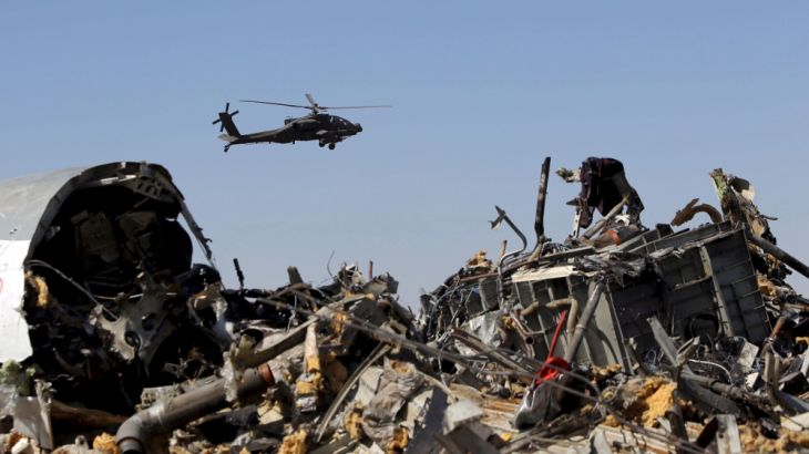 File photo shows an Egyptian military helicopter flying over debris from a Russian airliner which crashed at the Hassana area in Arish city