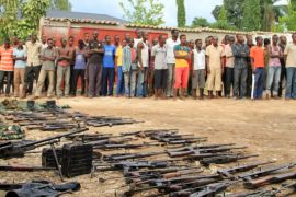 Suspected fighters are paraded before the media by Burundian police near a recovered cache of weapons in the capital Bujumbura, [Reuters]