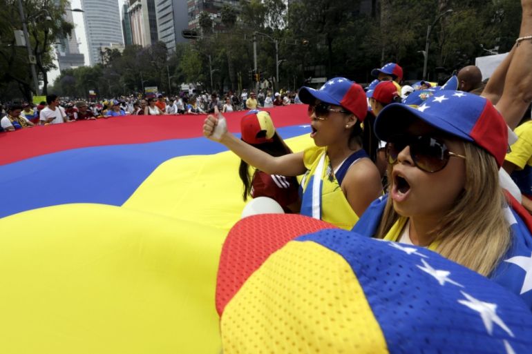 File photo of people carrying a giant Venezuelan flag during a protest in Mexico City of Venezuelan citizens residing in Mexico