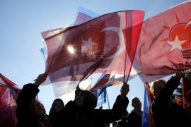Turkish AK Party supporters wave flags as they wait for the arrival of Turkish Prime Minister Davutoglu in Istanbul