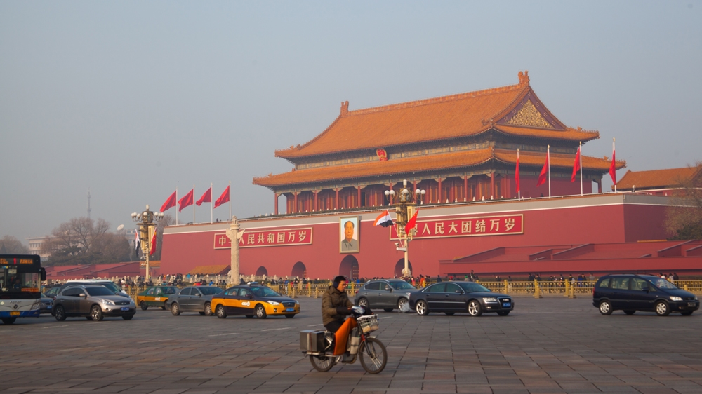 Mao Zedong's picture hangs at Tiananmen Square [Allison Griner/Al Jazeera]