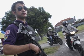 Indonesian policemen check motorcyclists during a road block to thwart an anticipate terrorism threat in Denpasar, Bali, Indonesia [EPA]