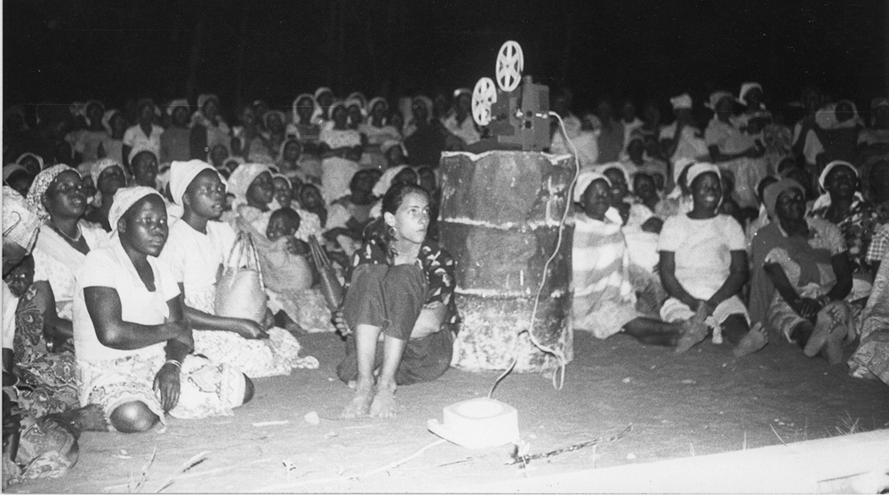 Nadine Wanono sits against an oil drum during a Study for Monument to Jean Rouch's Super 8 film workshop in Mozambique Col. J. Navacierra [Angela Ferreira]