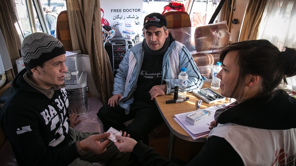 A mobile MSF station delivers medical assistance to refugees and migrants at the petrol station of Polikastro, about 20km from the Greek-Macedonian border at Idomeni [Nicola Zolin/Al Jazeera]