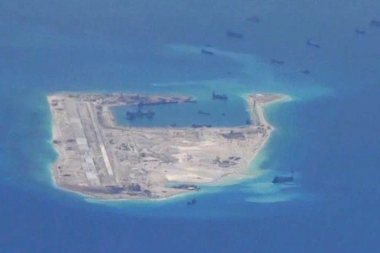 File photo from a United States Navy video purportedly shows Chinese dredging vessels in the waters around Fiery Cross Reef in the disputed Spratly Islands