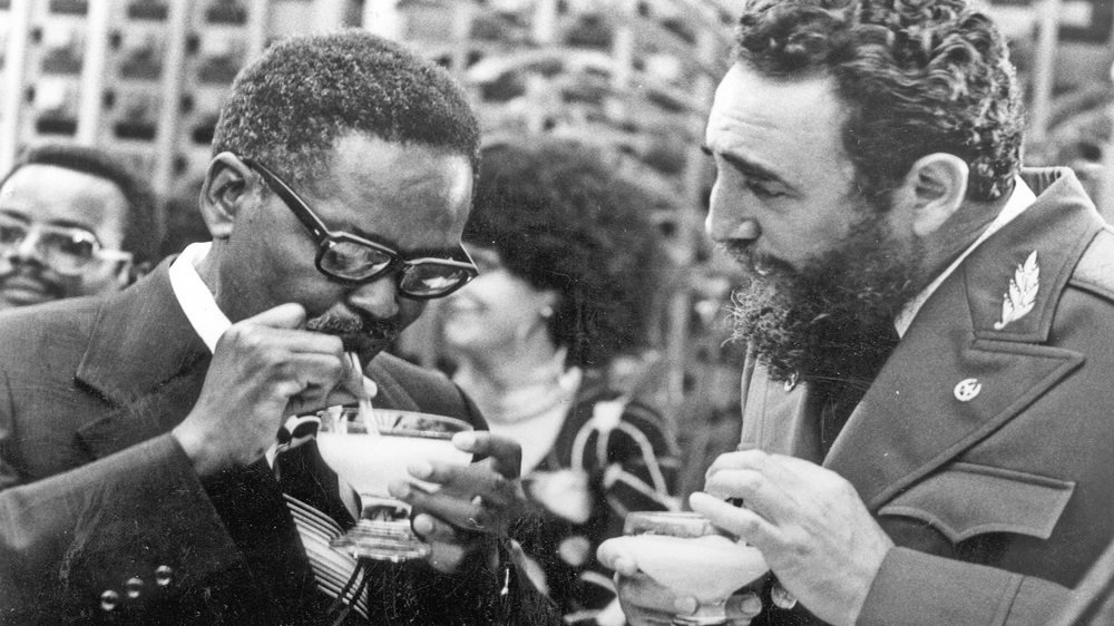 Cuban Prime Minister Fidel Castro, right, shows Angolan Movimento Popular de Libertacao de Angola President Agostinho Neto how to drink a daikiri in 1976 [The Associated Press]