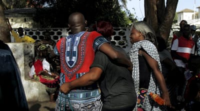 People comfort each other in Bassam, Ivory Coast [Reuters]