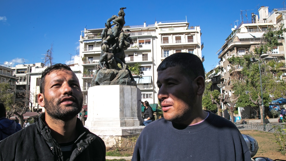A Libyan and an Algerian in Viktoria square, Athens, hope to continue their journey through Albania [Nicola Zolin/Al Jazeera] 
