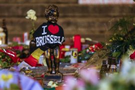 A replica of the Manneken-Pis statue is seen among flowers at a memorial for the victims of bomb attacks in Brussels metro and Brussels international airport of Zaventem, in Brussels [REUTERS]