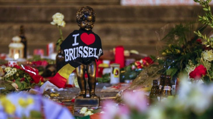 A replica of the Manneken-Pis statue is seen among flowers at a memorial for the victims of bomb attacks in Brussels metro and Brussels international airport of Zaventem, in Brussels [REUTERS]