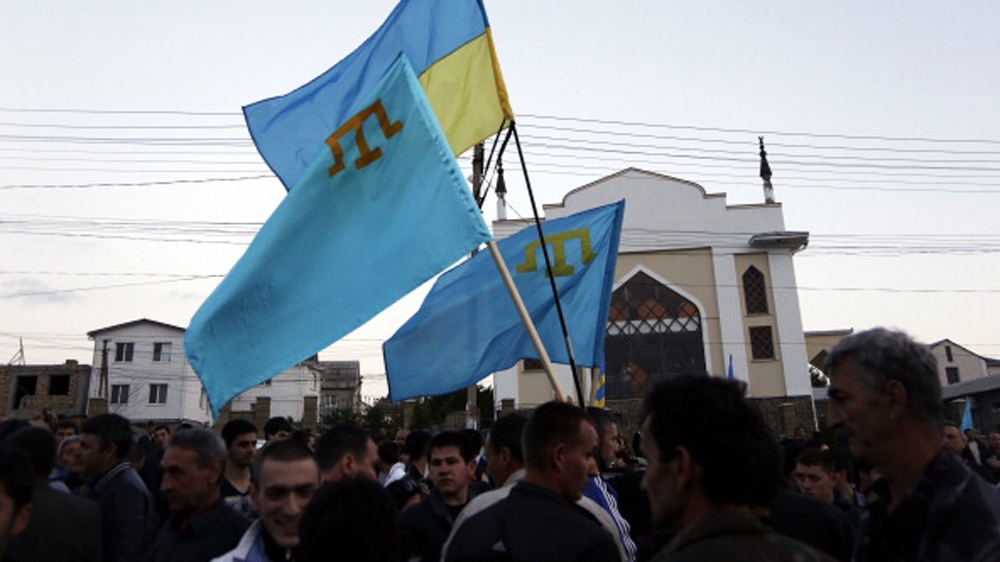 Crimean Tatars held Ukrainian and Tatar flags last year while commemorating the 70th anniversary of the deportation of Tatars from Crimea [ File: Getty Images]