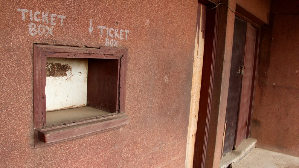 The box office of former Cinema Baba Sala is planked shut [Femke van Zeijl/Al Jazeera]