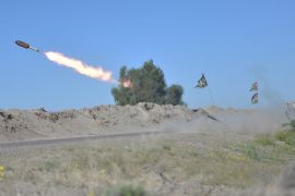 Iraqi fighters fire a rocket towards ISIL positions on the outskirts of Fallujah [Reuters]