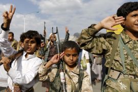 Armed boys join Houthi followers as they demonstrate against the Saudi-led air strikes in Yemen''s capital Sanaa