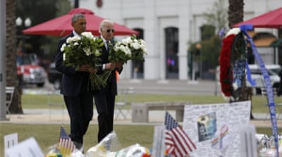 US President Barack Obama and Vice President Joe Biden place flowers at a makeshift memorial for victims of the massacre at a gay nightclub in Orlando. [Reuters]