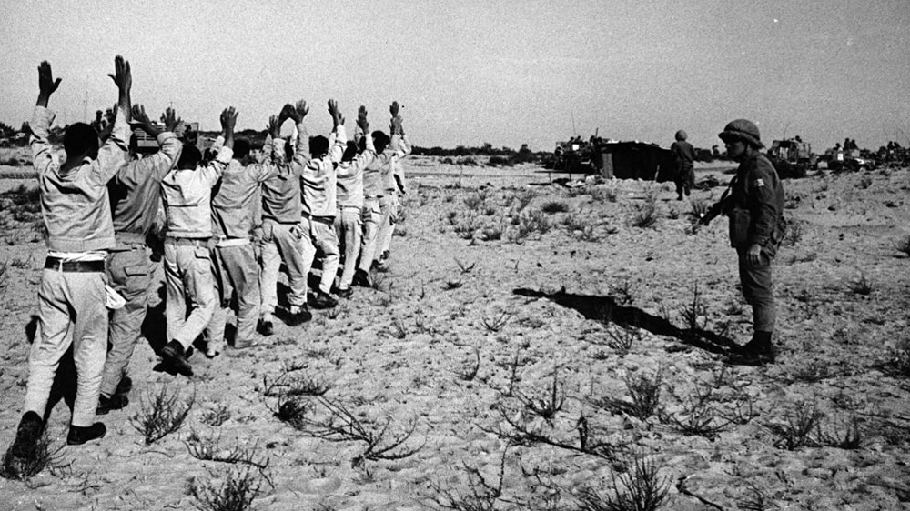 June 13, 1967: Egyptian prisoners of war hold their hands aloft after being rounded up by Israeli forces in the Sinai desert following the Six-Day War [Getty Images]