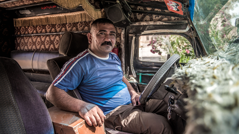 Saad Qader Hussein was among the first of Saadiya's residents to return after the town was recaptured from ISIL, but his taxi business has yet to recover [Tommy Trenchard/Oxfam/Al Jazeera]