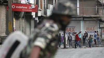 Kashmiri Muslim protesters throw stones at Indian police and paramilitary soldiers during clashes in Srinagar, capital of Indian Kashmir, on July 16 [EPA]