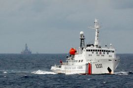 A Chinese Coast Guard vessel passes near a Chinese oil rig in the South China Sea [REUTERS]